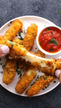 Why not try making your own homemade mozzarella sticks - they're easy and they taste oh so good! This simple recipe will show you how to make your own delicious mozzarella sticks in less than 30 minutes. String cheese sticks are coated in batter and deep fried to golden, melted cheesy perfection - try out this easy mozzarella sticks recipe. You won't be disappointed! I've also included my favorite marinara sauce recipe for dipping. | easy fried mozzarella | fried cheese sticks