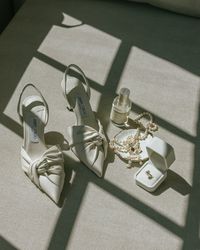 The modern bride wears classic Jimmy Choos with a fashion-forward twist, Le Labo perfume, her grandmother's pearls, and classic pearl earrings with a modern twist