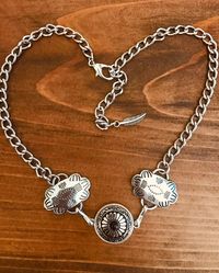 Beautiful hand crafted western choker.  These are man made silver conchos  indian aztec design and floral has tiny colored  stone.  Faux silver concho feather at the very end. This choker has Lobster clasp.   This is a Unique style not to be found anywhere but Old hands Creations! This one is  16.5"  extends to 18.5" in total length. Check out our chain belts that will match this perfectly.   Please check out our other items as some are complimentary to this item. If you buy 2 or more items you