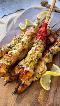 Lemon Garlic Parmesan Chicken Skewers- juicy, tender and packed with so much flavor! These are a summer staple at home and perfect to enjoy with salads, any sides or on its own! They are also great for hosting and so easy to hold!  Ingredients:  2 lbs @bellandevans chicken tenders  1/2 cup olive oil  2 garlic cloves 1 tbs fresh parsley, chopped  1/2 lemon, juiced + zested 3 tbs Parmigiano Regiano, grated  1 tsp salt  Black pepper, to taste  @im_crushn Smoky chili flakes   Method:  1. Soak skewers in water so they don’t burn; 2. Cut tenders into chunks that are about the same size;  3. To make the marinate- mix olive oil, lemon zest + juice, garlic, parsley, Parmigiano Reggiano, salt and pepper;  4. Pour marinate over as you reserve a bit to brush after grilling;  5. Pierce meat on the skew