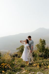 Brooklyn Grace Photo,Engagement Photos, mountain engagements, Utah locations, engagement outfits, engagement poses, Big Cottonwood Canyon, Jordan pines, couples, Summer Engagements, Provo Canyon, black and white oufits, wild flowers, couples poses, white dress