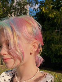 This dreamy pastel rainbow hairstyle is a celebration of soft, vibrant hues. Delicate strands of pink, blue, orange, and yellow cascade through the hair, creating a magical and whimsical aesthetic. The subtle blending of colors makes this look both striking and harmonious.