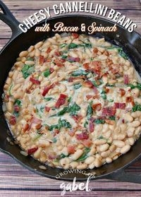 Turn 2 cans of cannellini beans into a delicious side dish! This cannellini bean recipe is made with bacon, onions, garlic and spinach for a delicious, healthy and cheap recipe! #MyBestWithBushBeans AD