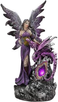 PRICES MAY VARY. This Purple Fairy With Dragon LED Crystal Geode Statue is approximately 9" tall and 5.5" long and 3.5" deep. She weighs about 11 ounces. This Purple Fairy With Dragon LED Crystal Geode Statue is made of designer composite resin, hand painted and polished individually. Color Tone may vary This sculpture is a gorgeous and stunning piece of art. Our sculptors and painters have done an excellent job in creating great details to the face of the fairy and the overall flow of the body