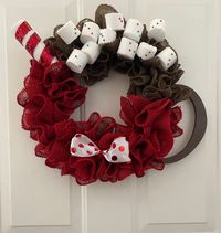 "Hot Cocoa Wreath- This Winter Wreath replicates a warm cup of hot cocoa complete with marshmallows and a candy cane stirrer! Red ruffles of burlap make up the \" cup\" portion of this wreath. Brown ruffled burlap is used as hot cocoa. Foam marshmallows with tiny sprinkles sit on top. A red and white candy cane stirrer sits to the side. A red and white polka dotted bow sits on the bottom of the cup. A brown handle completes this oh so sweet cup of cocoa! Perfect wreath for display all winter lon