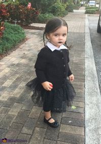 My 2 year old daughter Arabella About a month ago a family member told us that she looks just like Wednesday Adams from the Adams Family movie I just purchased very ominous looking clothing and decided to make a sparkly tutu to dress it up a... Photo 2 of 2.