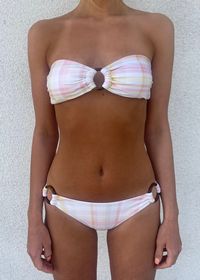 Your new go-to bikini set in a cute pink checkered pattern. Classic bandeau top and low waisted bottoms with beautiful ring details. Removable padding.