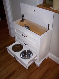 Made from small dresser. Food is kept in top w scoop. Drawers hold all pet supplies, leash, collar, sprays, etc. Would be great as a built in for the mudroom:)