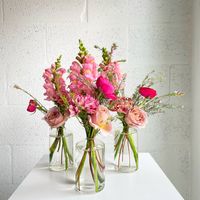 we are pretty obsessed with our bud vase arrangements because there are infinite ways to style and place them! these tiny moments come with a handful of stems, filler and greens in the cutest little bud vase (.25 inch opening) you've ever seen. choose from three different color palettes: designer's choice: let us choose from the best of what we have each week! romantic pinks: shades of pinks and purples white & nude: shades of white, cream, nude, and beige what you'll get: a mix of our weekly seasonal florals and greens, in your chosen color story, styled in a glass cute little glass bud vase filled with just enough water for the ride home.