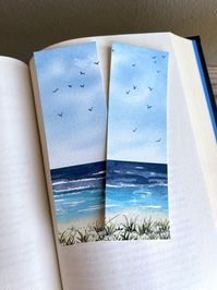 This gorgeous bookmark features a loose and expressive watercolor beach painting with vibrant blue water, soft sand, and birds flying in the sky. It's a great way to bring the peace and warmth of summer into your reading! This bookmark would make a thoughtful gift for a friend or loved one, or a nice little present for yourself! NOTE: Each order is for 1 bookmark! These bookmarks are hand painted to order on Arches watercolor paper using Winsor & Newton professional watercolor paints. Arches pap