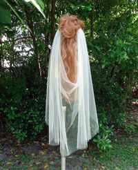 Wildly romantic with an elegant drape and dramatic scooped back, this  draped veil is  is a perfect addition to a modern bohemian bride's look. Handcrafted from very soft illusion tulle made in the USA, this veil loves to shows off your flawless bridal hairstyle and the back of your gown.  Veil shown is 45"/Knee length with a circular cut edge with two hand-sewn 5-tooth metal combs. Wear this veil on its own for effortless glamour, or pair it with a bridal crown or comb for an ultra-chic look. O