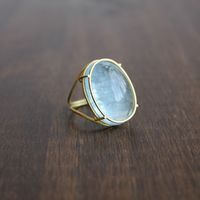 Rosanne Pugliese 18k Gold and Oval Aquamarine Ring in a cage setting. Available at Meeka Fine Jewelry.