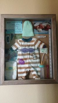 My shadow box I created for my little boy all thethinga that he had and his first memories from the hospital. His preemie stuff oncluded as well as information, pictures, and medical neccessities. Absolutely loved this when I got it done!