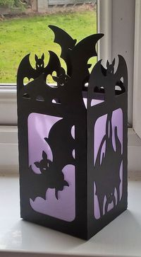 Halloween luminaries made from a free SVG from The Dreaming Tree... Black card, and purple parchment...