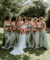 sage green bridesmaids dresses with colorful flowrs in light pink, yellow & white