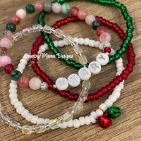 This is an adorable stack of five micro bracelets in a range of holiday colors with one strand saying Merry and bell charms