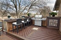 A barbeque nook with side tables & a built in cabinet, and a large dry bar perfect for serving food or enjoying the view. From “Decked Out” project “The Whole Family Deck”. Deck Design by Paul Lafrance Design.