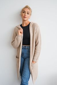 DetailsAn oversized long cardigan featuring a hood, pockets, and long sleeves Model is wearing a size Small. Content + Care- 56% Acrylic- Hand or machine wash cold Size + FitMeasurements taken from size Small.-Full length: 37" -Bust: 46"-Sleeves: 23"