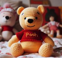 In the cozy nooks of amigurumi land, the Winnie the Pooh amigurumi sits sweetly, bringing A.A. Milne's cherished storybook bear to life with the warmth of