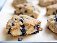 Despite containing both coconut oil and coconut milk, these scones don't end up with a coconutty flavor at all. Rather, these ingredients provide the same richness and tender but fluffy crumb you'd find in traditional scones made with butter and cream. Their flavor is light and lemony, with bursts of juicy blueberry under a crunchy crust of toasted sugar. Do be sure to refrigerate the dough, which mixes up a little warmer and softer than a typical scone dough made with chilled dairy ingredients.