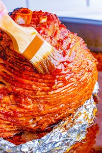 Honey Baked Ham - Spiral baked honey ham that's SO EASY you really can't mess it up! The sweetness from the honey works perfectly with the saltiness of the ham. This ham is similar to the honey baked ham everyone loves to purchase but so much less expensive! Perfect for HOLIDAY MEALS and family dinners!