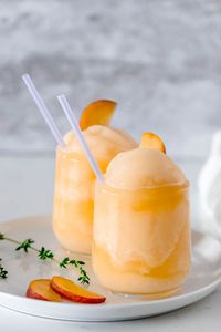 Frozen Peach Bellini Cocktail - Light, refreshing and super easy to make! This elegant cocktail slush will be a hit for any summer party.