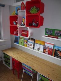 Colorful Shelving made from IKEA plastic boxes. I also like how the table / workspace is done.