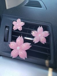 "A New Style of Pink and White Marbled Sakura Cherry Blossom Car Vent Clips In the color: \"Pink Dreams\" (pictured) Can be made in the following colors: \"Pink Dreams\" (pink) \"Lilac Skies\" (light purple) \"In the Clouds\" (blue) \"Cotton Candy Clouds\" (pink and blue) Comes in a pack of four (3) vent clips. Pack of 3 Universal Fit Vent Clips: Multiple Sizes of Sakura Flowers These vent clips match other car accessories in my shop, such as valve stem caps, car coasters, trinket boxes and HK t