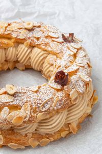 Paris-Brest with nutty Creme Mousseline filling with a white background.