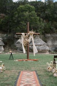 My favorite detail, my sweet husband hand made this cross out of the same metal our ranch is fenced in. Terroir designs knocked the florals out of the park and I sourced the rug from a maker in india. My dream western wedding.