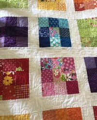 This sweet little quilt is one of a kind. It is a nine-patch with every color of the rainbow. I use only high quality designer fabric from quilt stores. This quilt is 40" by 48". It could be used also for a wall hanging or a throw on your bed to brighten up your bedroom. Or toss it on your couch to use as a lap quilt.