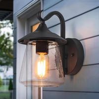 Add a modern flair to your front porch or patio with this LNC Modern Frosted Black Porch Outdoor Wall Sconce. With clear seeded glass and a metal frame with a durable black finish, this fixture has a timeless style that's built to last. Couple two sconces on either side of your entryway or garage door for a classic look.