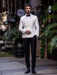 Color: white Material: 65% polyester, 35% viscose Suit includes blazer & trousers Single-breasted suit (6 button blazer) Lapel type: shawl lapels Jacket interior lining option: fully-lined Jacket vent: double vent  Fitting: slim-fit Care instructions: dry clean only  Machine washable: no