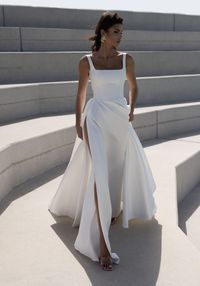 Embody timeless elegance on your special day with our A-Line wedding dress. Made of luxurious satin with wide straps and a square-cut corset, this dress will enhance your figure and make you feel like a true bride. Shop now at Aliana for a sophisticated and graceful bridal look.