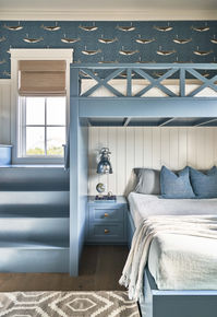 A bunk room for the kids with white shiplap and whale wallpaper. Custom new build waterfront home in Figure Eight Island, NC, designed by Herlong Architects + Interiors