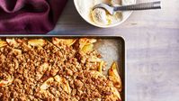 Using a sheet pan instead of the typical glass baking dish for this apple crisp ensures crispy edges all around. And don't forget the vanilla ice cream!