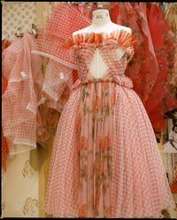 A glass organza garden rose and gingham dress is created in the atelier.