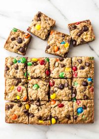 These cookie bars are like a soft oatmeal cookie in bar form. These are baked in an 8x8 pan, use melted butter, and don’t require a mixer - easy and fast! #cookies #oatmealcookie #bars #nomixer #kidfriendly #makewithkids