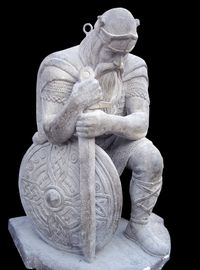 Ancient kneeling Norse warrior statue from Norwegian church