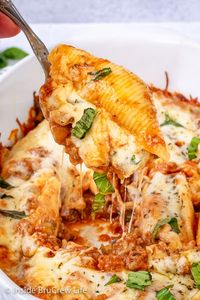 Classic Stuffed Shells - a creamy three cheese filling and meat sauce makes this comfort food taste amazing. Make this easy recipe for dinner or freeze for later.