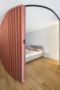 Red curved Dooor inside Milano Apartment