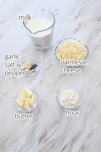 Alfredo sauce ingredients on a marble surface.