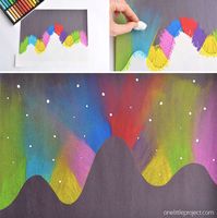 This simple northern lights chalk art project for kids is so much fun and makes such a gorgeous glowing sky over the mountains! It's a perfect activity for a snow day and also easy enough for a teacher to make with the entire class at school.