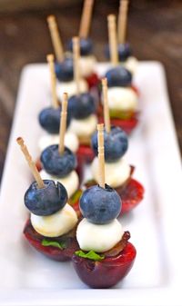 Mini Fruit Skewers Recipe can be made ahead and are the perfect 4th of July appetizer! Fresh, festive and fun, they are over-the-top delicious and great for any outdoor barbecue or summer party. #redwhiteandblue #july4th #skewers #kebabs #bacon #blueberries #cherries #mozzarella #appetizers