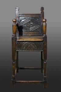 A late Elizabethan oak and fruitwood child's high chair. Carved fruitwood back panel with lozenge and leafy spandrels, seat rails carved with a single large lunette. Another child's high chair from the same workshop sold in the Clive Sherwood sale lot number 349 and also exhibited by BADA, June 1988 in the exhibition titled ( England at the tyme of the Armada ) plate 16, in catalogue. The same chair is also pictured in Tobias Jellinek book, Early British Chairs and Seats 1500 to 1700.