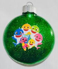 Baby Shark glitter Christmas ornament Shatterproof Plastic disc ornament Name and Year can be put on back of ornament Will ship out by 1-3 business day with a tracking number Free personalization includes-1 name and 1 year per ornament Due to our products being 100% homemade, our products may slightly vary from the product listed. Please contact us with any issues.