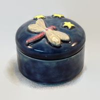 Bring back summertime memories of dragonflies dancing over water with this Starry Night Dragonfly themed Ceramic Keepsake Box. It measures approximately 3 inches in diameter and 3 inches tall. The inspiration for this ceramic keepsake box is delightful dance of dragonflies that my sons and I watched at the lake. Dragonflies symbolize many things across many cultures: agility, good luck, happiness, harmony, power, prosperity, purity and speed; making this the perfect gift for the graduate or the