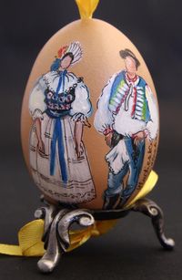 chicken egg with a delicate painting of a couple in traditional slovak costume