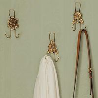 <p>Offer both elegance and functionality in almost any room with our <strong>Golden Flower Iron Wall Hook Set of 3</strong>. Each hook in this set features a unique flower design and two prongs to provide a secure and versatile hanging solution. Add this hook trio to your entryway wall space for a place to hang keys, bags, coats, and other accessories functionally and stylishly. Purchase your favorite style individually or indulge in the set to adorn your wall with a harmonious