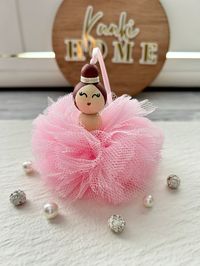 Red tulle Pom Pom Ballerina. Wooden bead head painted, tulle Pom Pom and ribbon. This ballerina comes in red, blue, purple, yellow, cream. Included gift box.